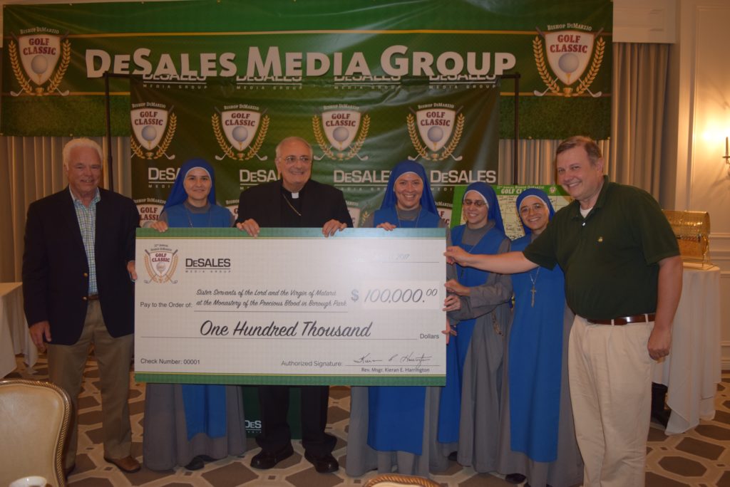 Bishop DiMarzio , four nuns and two men with Oversized Check