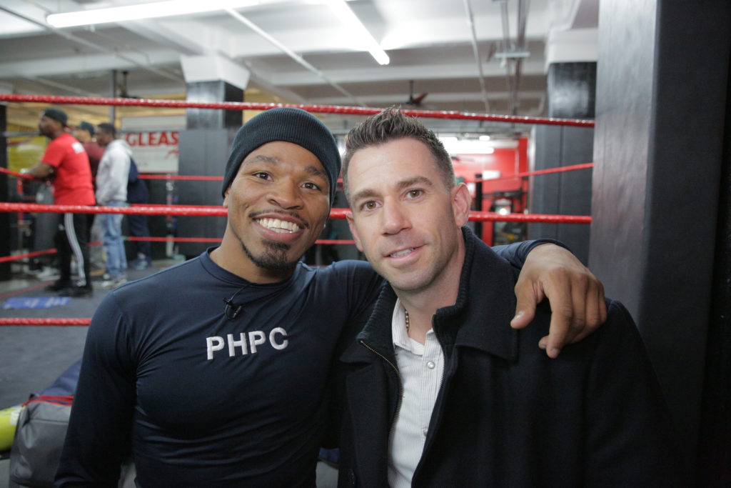 Two men in front of a boxing ring